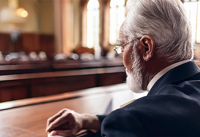a man sitting at a desk in a court room